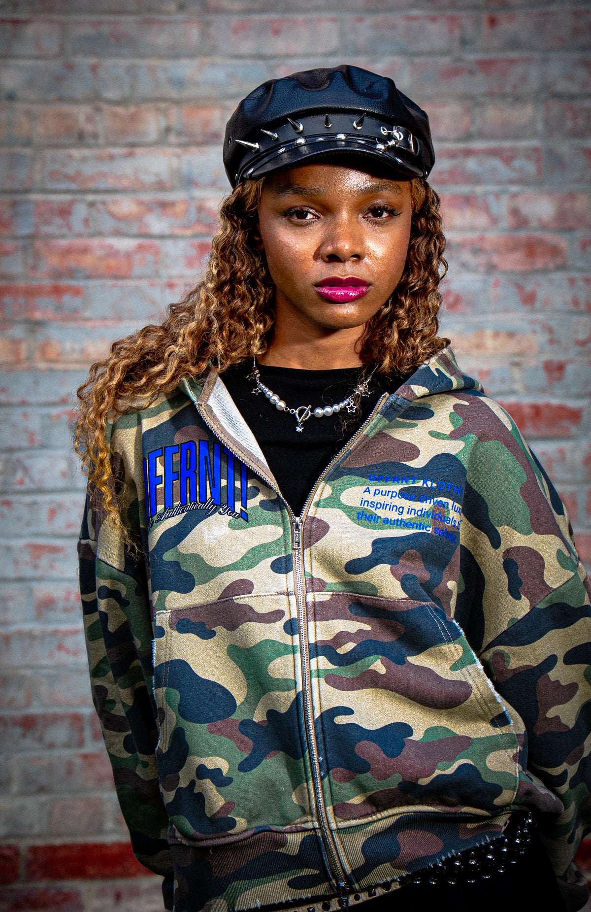 Model wearing the Standard 400 camo hoodie with blue Dffrnt graphics