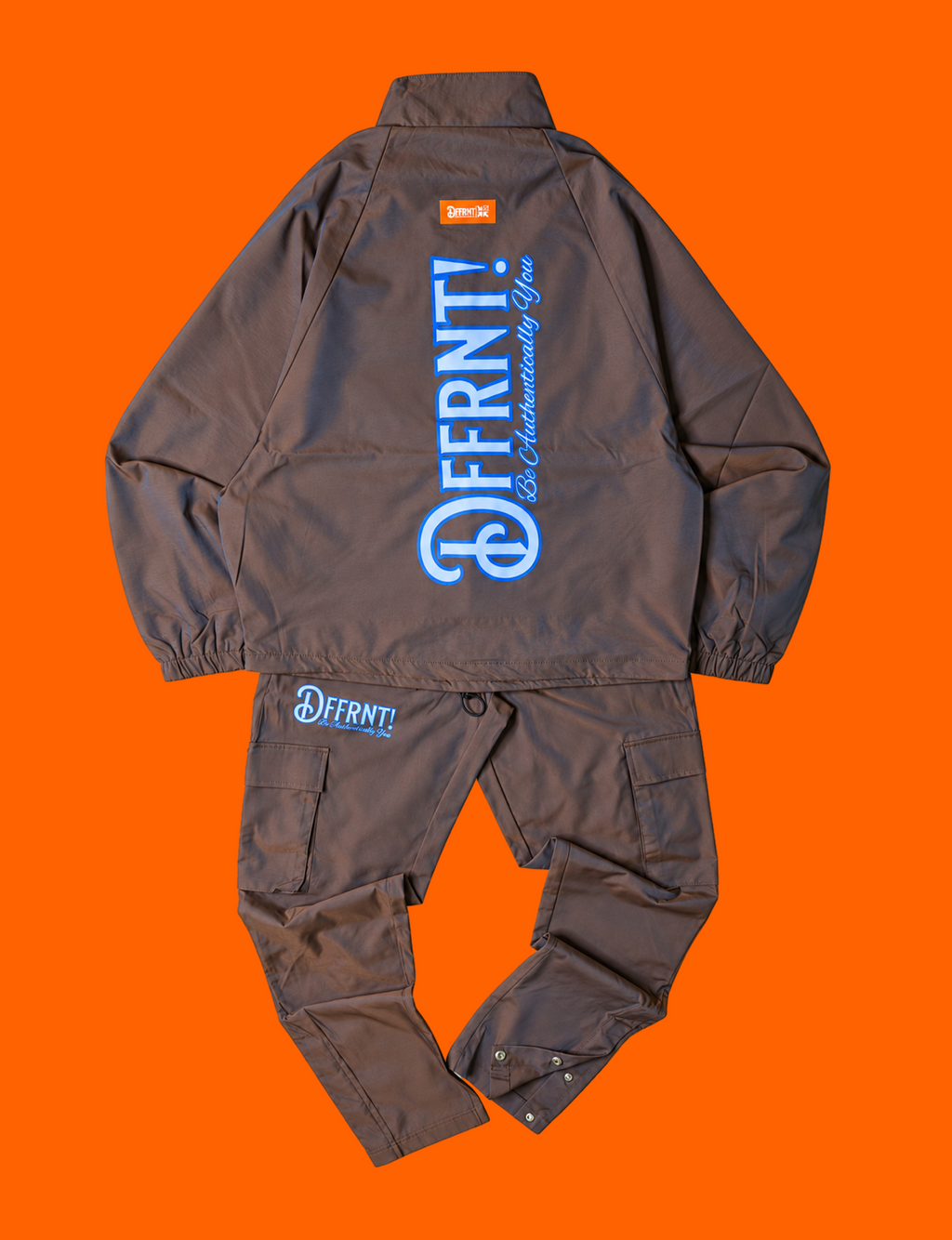 The Standard Tracksuit in brown with blue sheen and two-tone blue graphics — back view