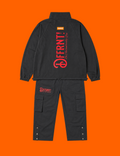 The Standard Tracksuit in black with two-tone black-and-red graphics — back view